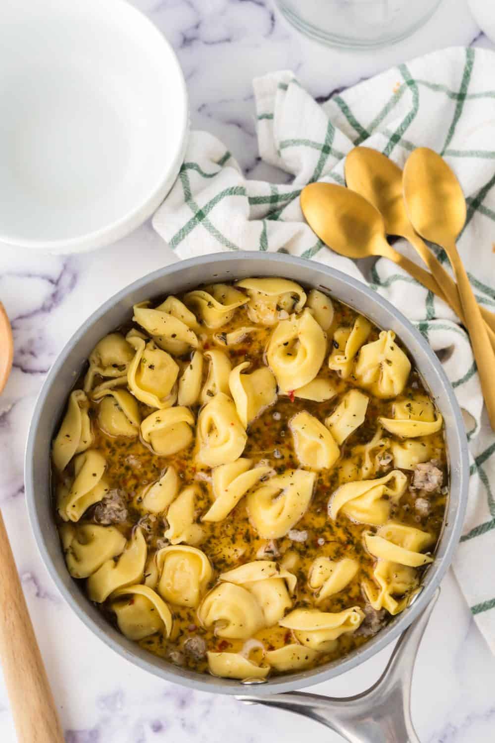 pot of ingredients for sausage tortellini soup