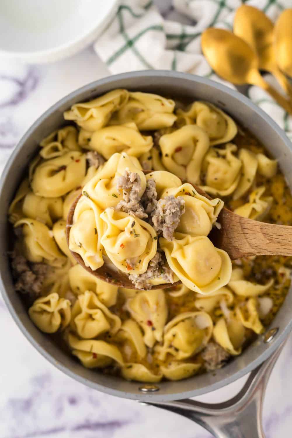 pot of ingredients for sausage tortellini soup