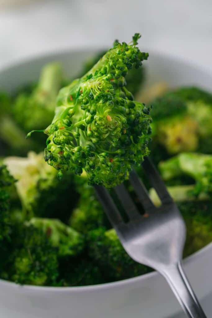 POV forkful of sautéed broccoli