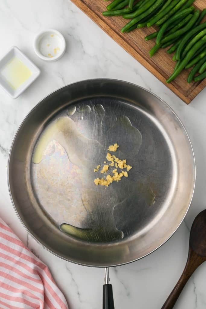 a pan with oil and garlic