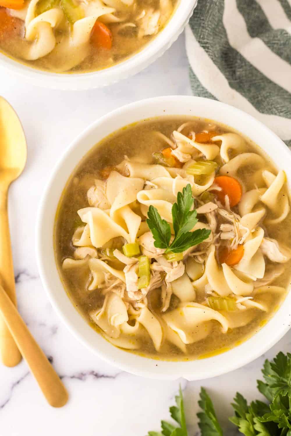 white bowl of turkey noodle soup served and ready to enjoy