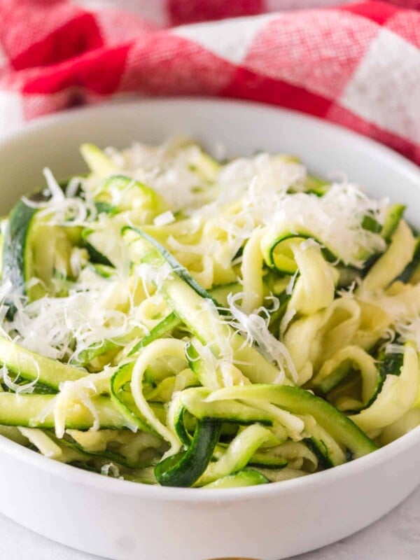 bowl of fresh zucchini noodles with parmesan on top