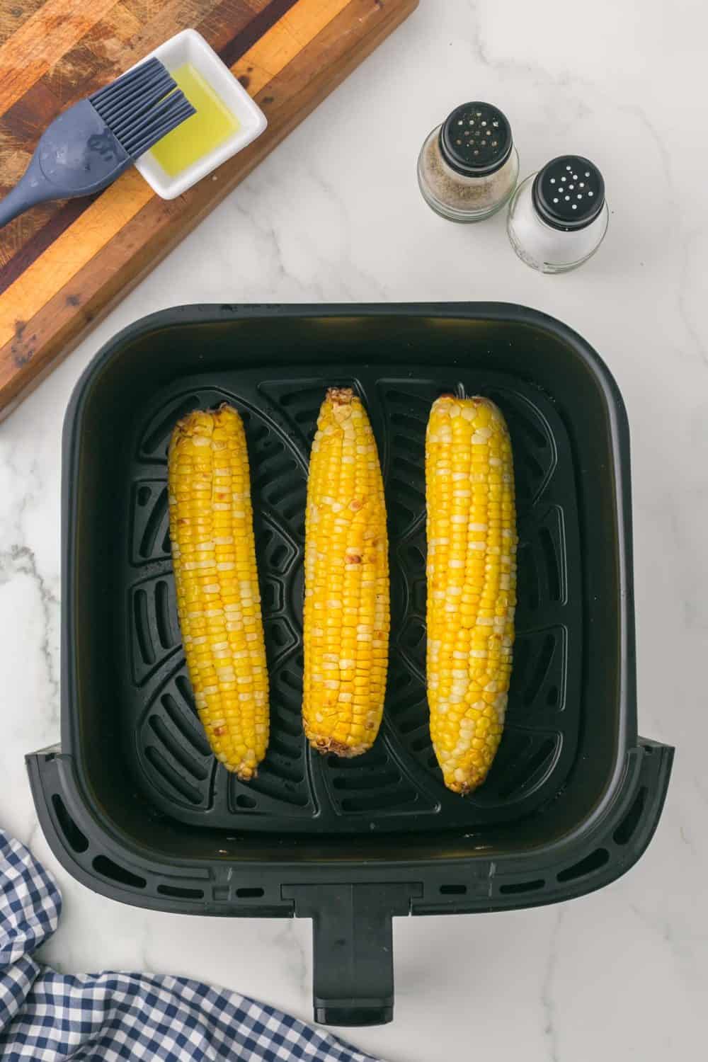 baked corn cobs in the air fryer basket