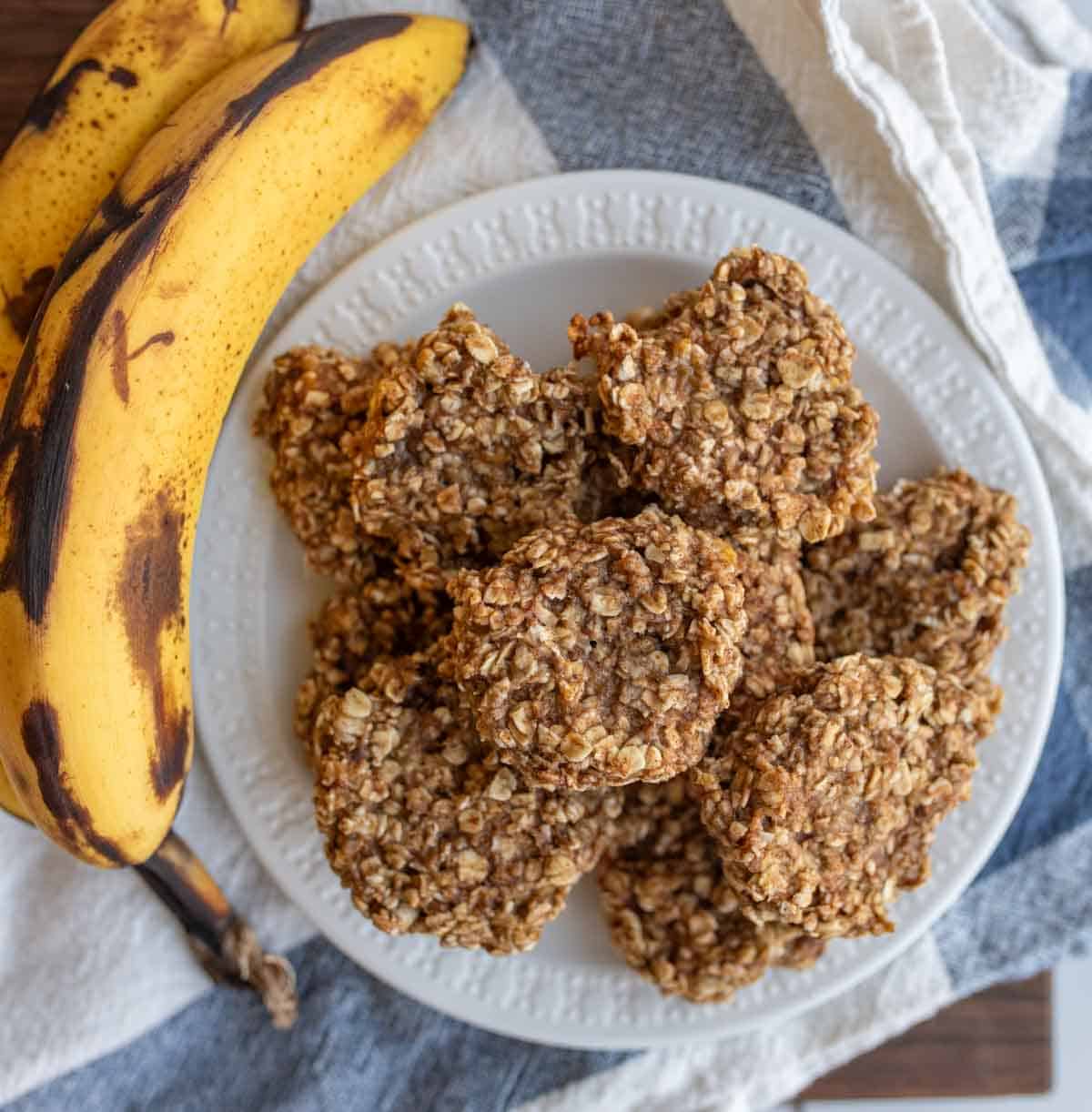 banana oatmeal cookies stacked on a white plate