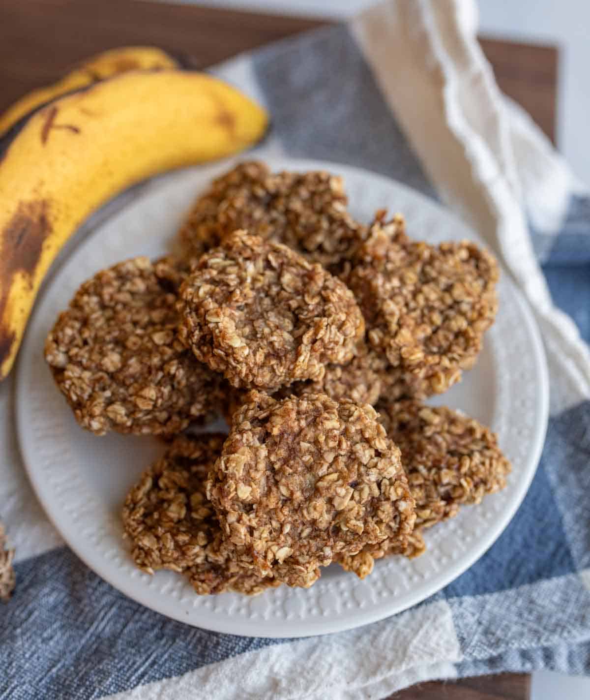 banana oatmeal cookies stacked on a white plate