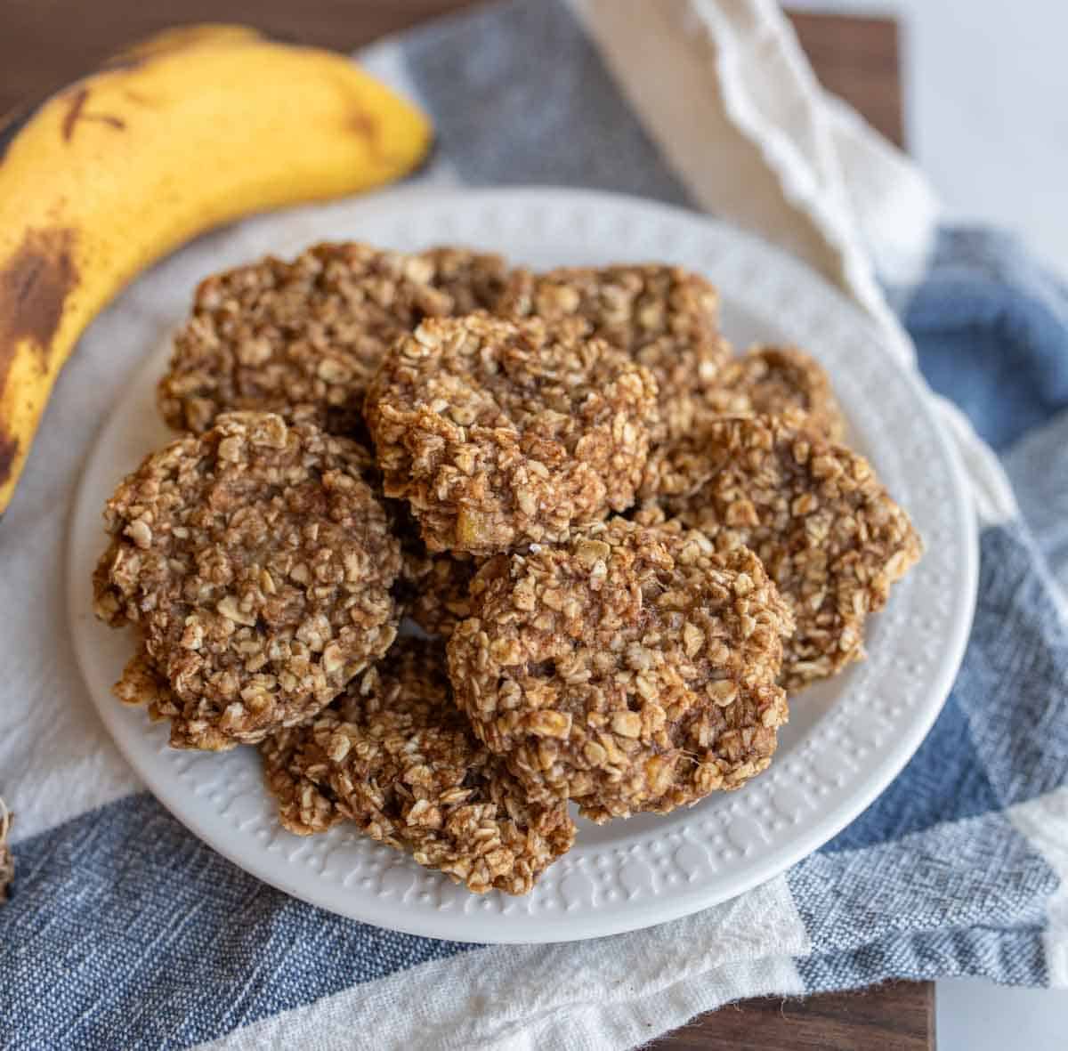 banana oatmeal cookies stacked on a white plate