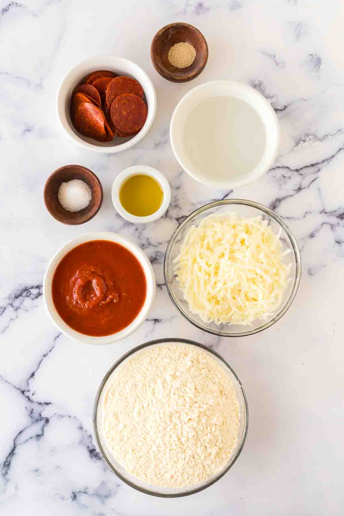 raw ingredients for brooklyn style pizza in portion dishes