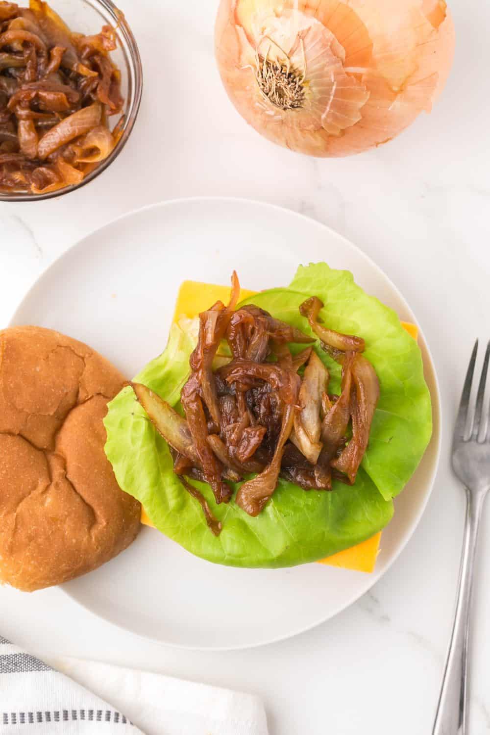 caramelized onions on lettuce on a bun