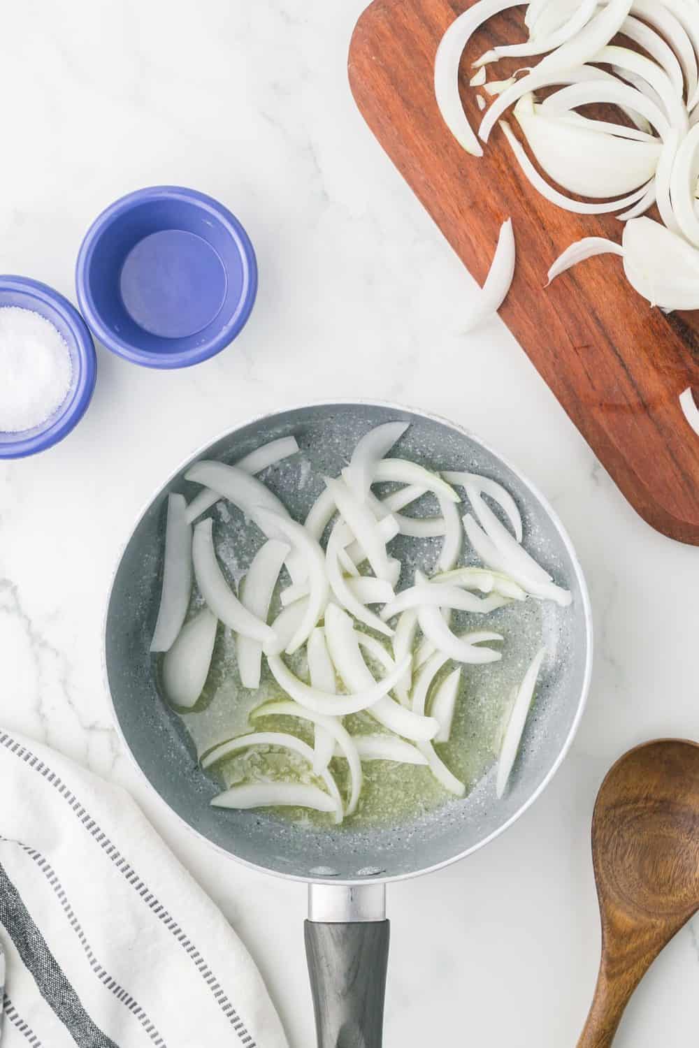 raw diced white onions in a pot