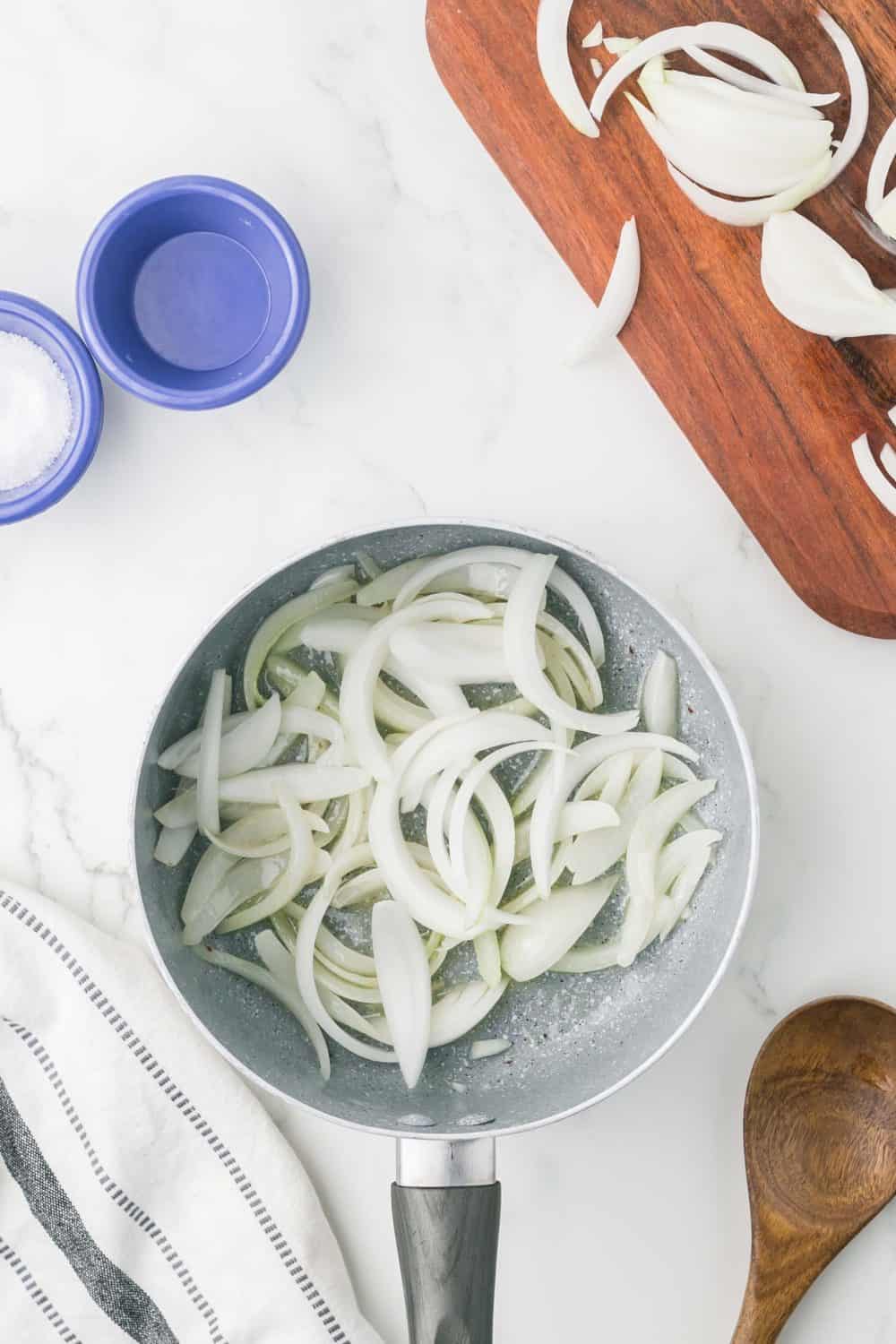 raw diced white onions in a pot