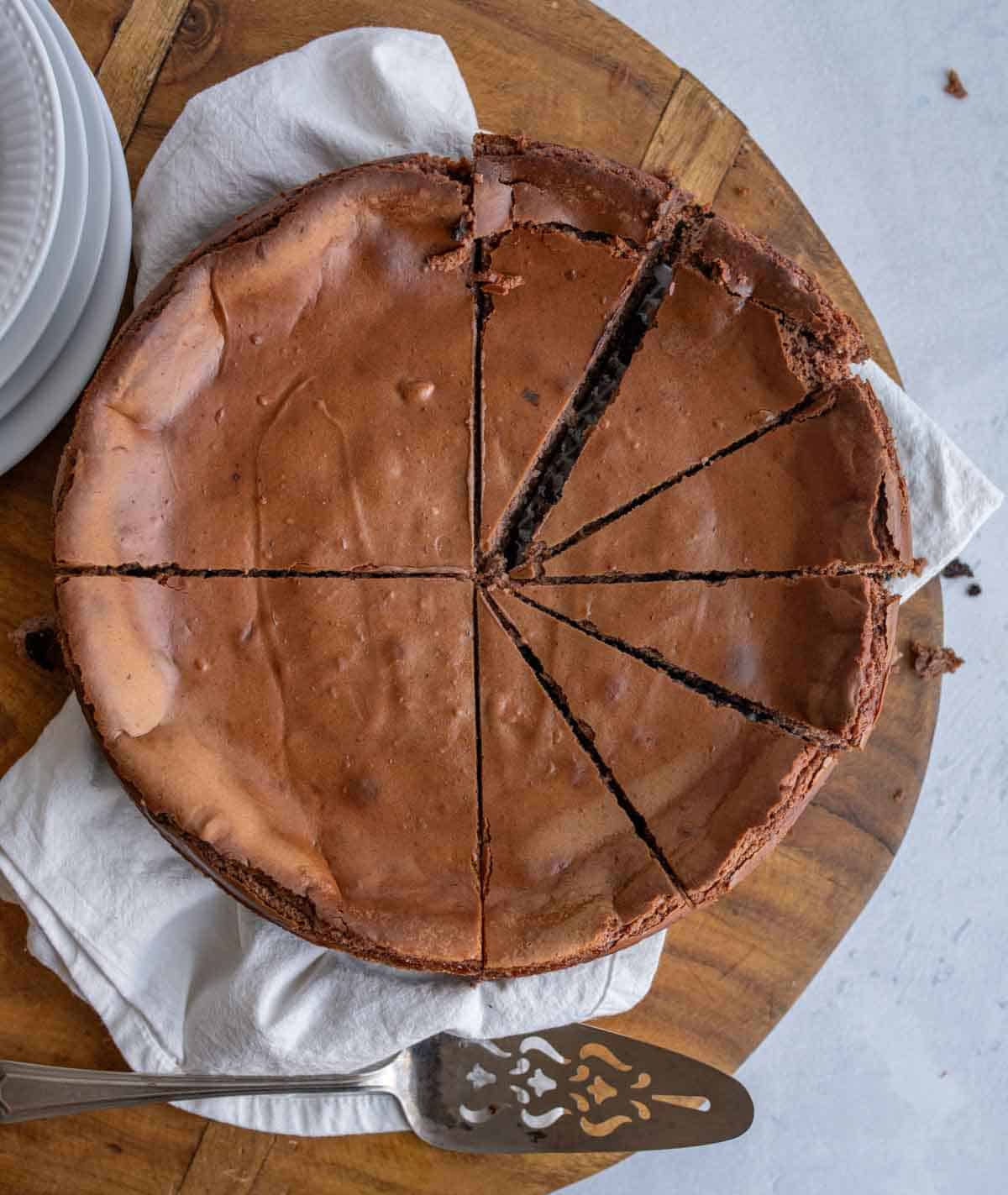 whole chocolate cheesecake sliced into perfect wedges
