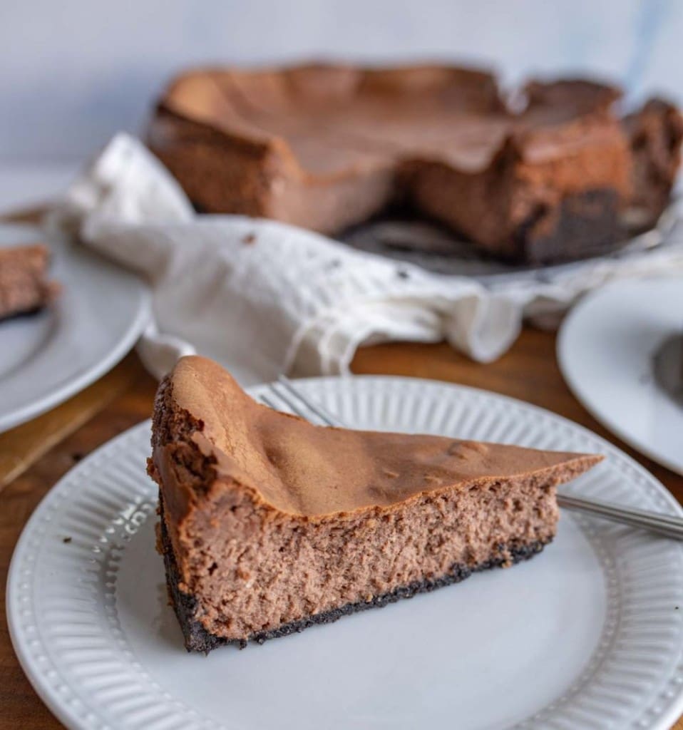 Side view of a slice of chocolate cheesecake.