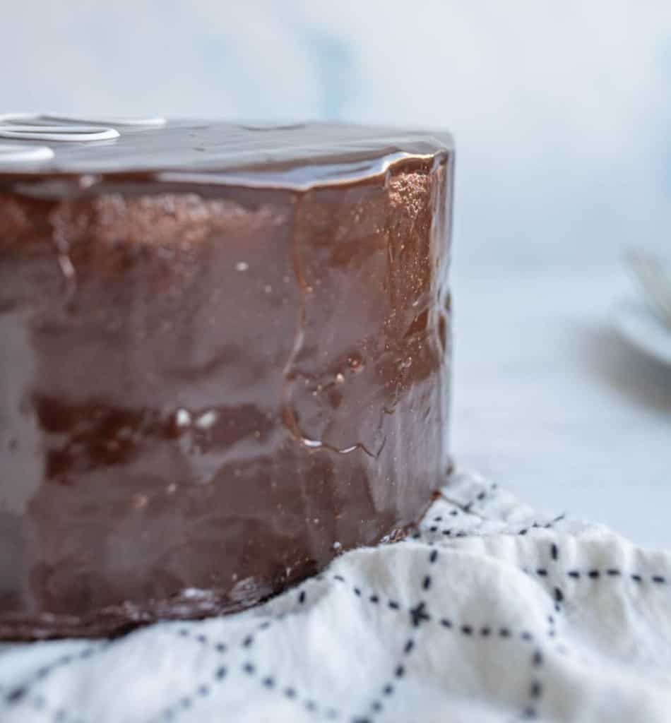 chocolate ganache poured over a whole round layer cake