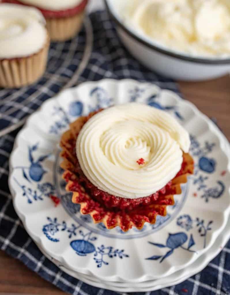 Single cupcake with cream cheese frosting.