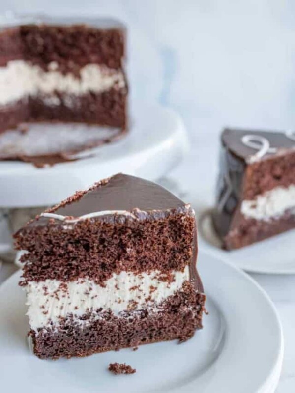 triangle serving slices of chocolate cake with two layers and white frosting in the middle
