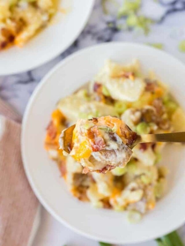 twice baked potato casserole on a white plate and a spoon