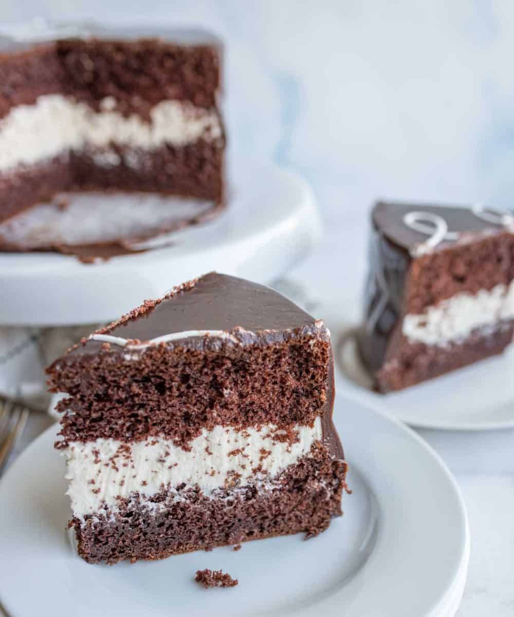triangle serving slices of chocolate cake with two layers and white frosting in the middle