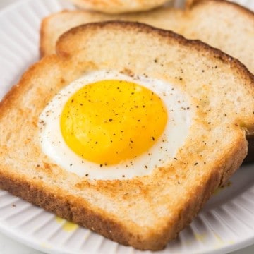 egg fried in a hole of toast on a plate