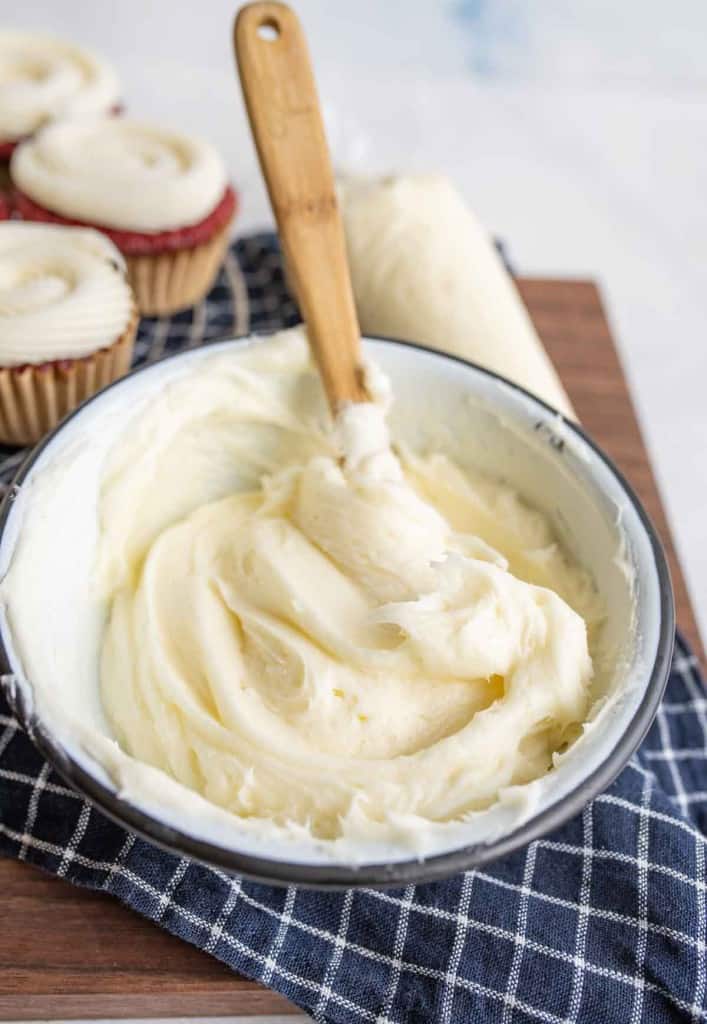 image of white cream cheese frosting in a whipped mixing bowl