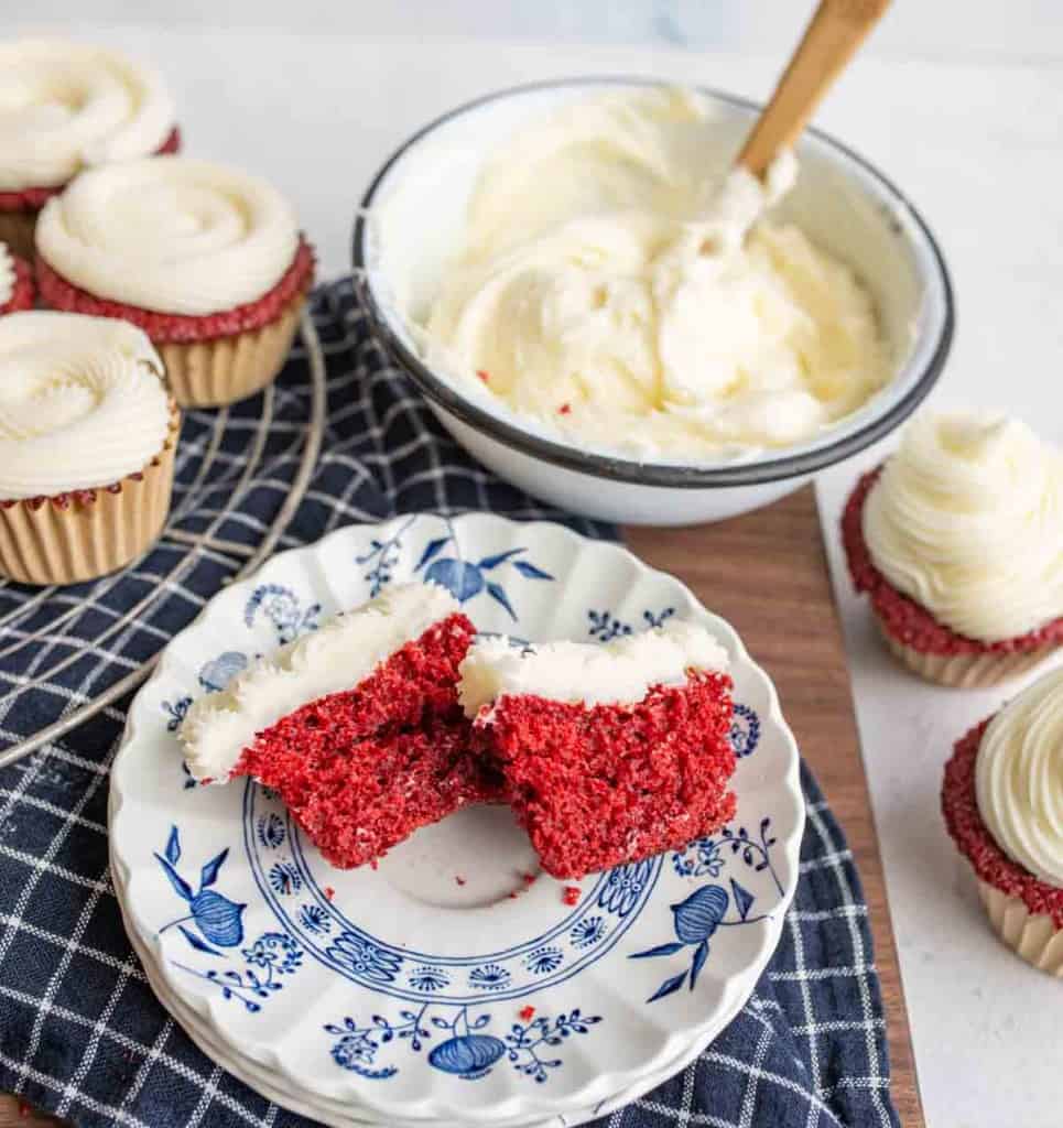 image of red velvet cupcakes with cream cheese frosting in a bowl on the side