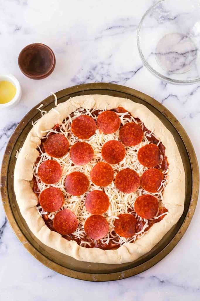 raw stuff crust pizza with pepperoni before baking