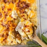 close up of twice baked casserole and a wooden spoon scooping it out