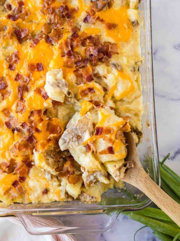 close up of twice baked casserole and a wooden spoon scooping it out