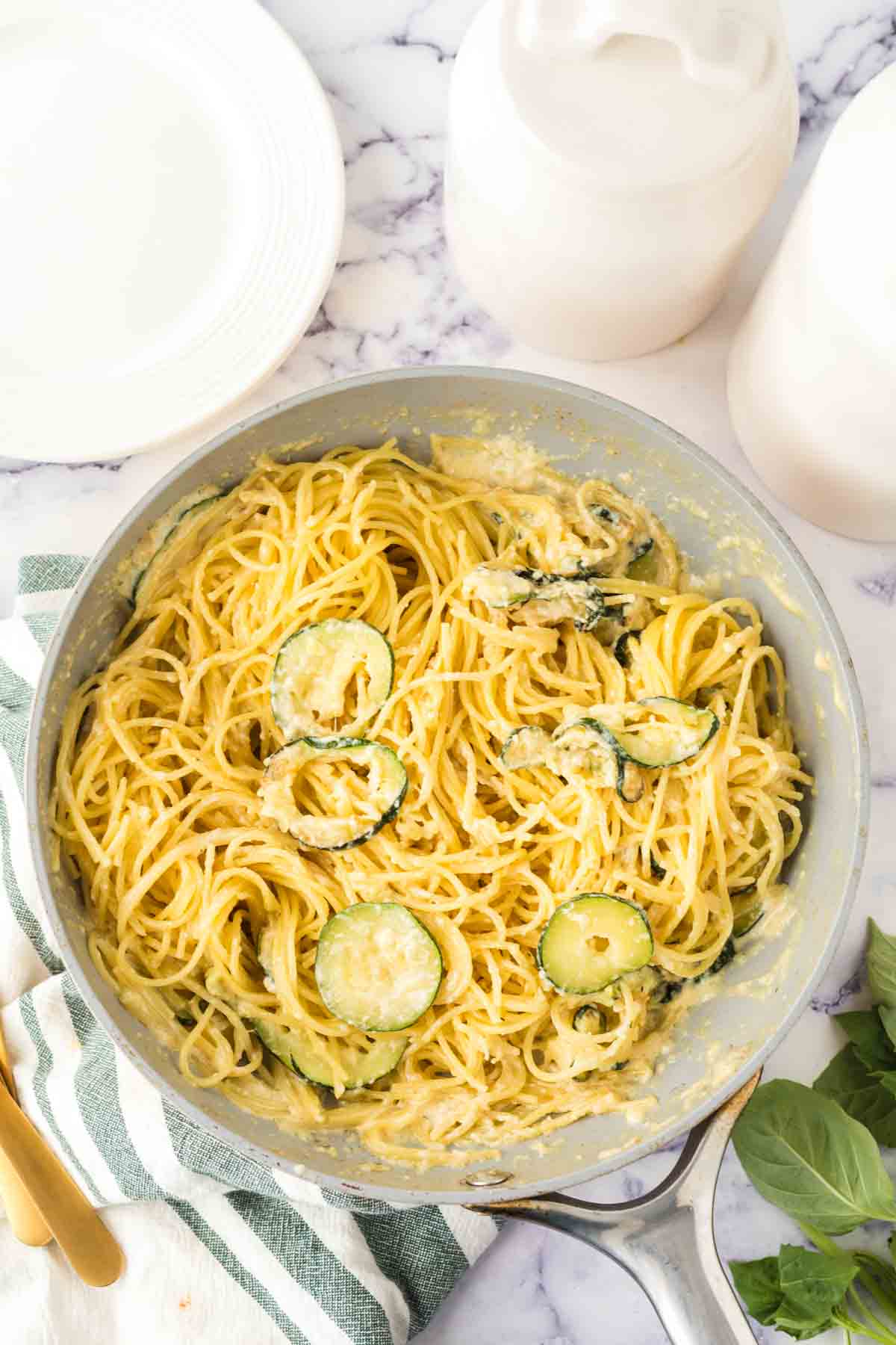 sliced zucchini in a pan with pasta