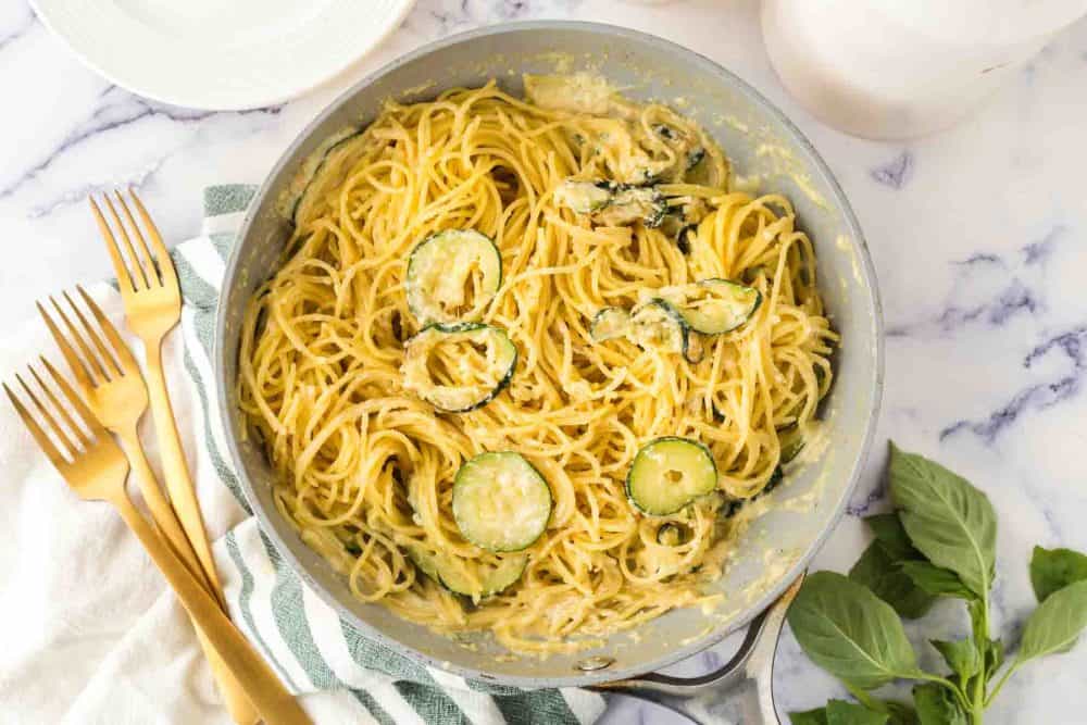 sliced zucchini in a pan with pasta