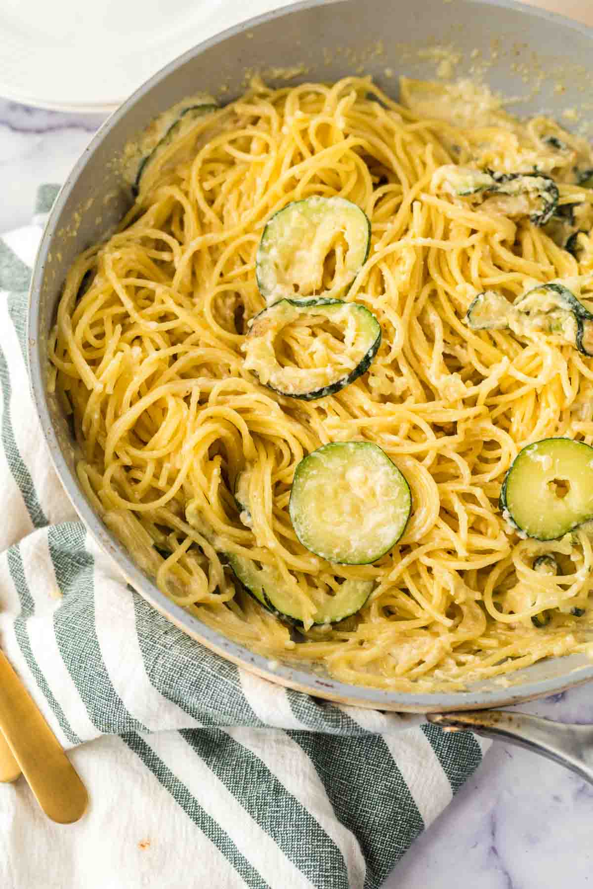 sliced zucchini in a pan with pasta