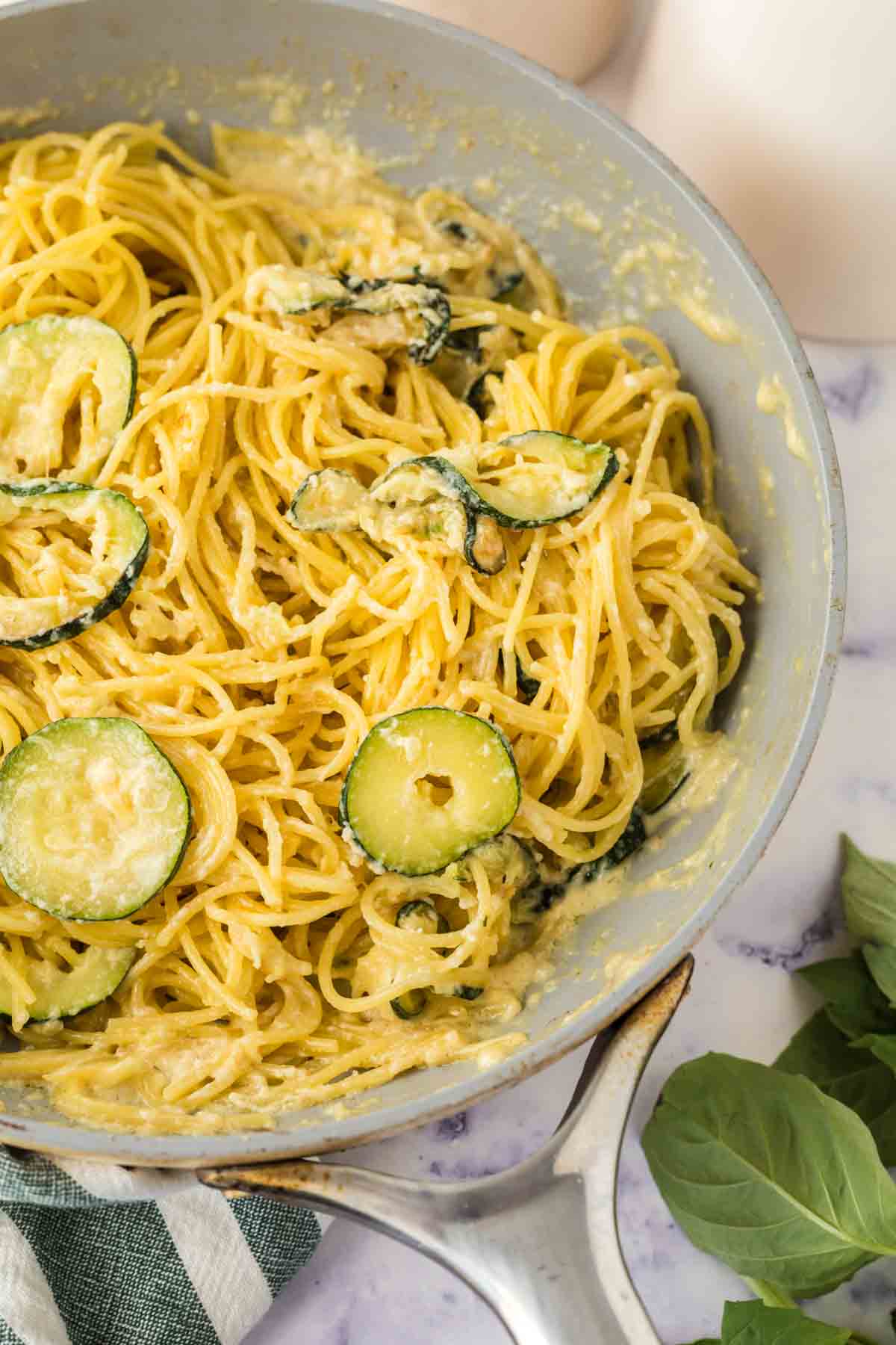 sliced zucchini in a pan with pasta