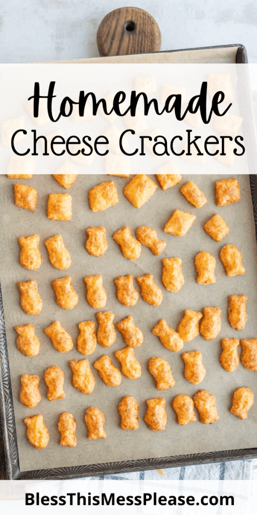 pin with text that reads homemade cheese crackers with baked cheese fish shaped crackers on a baking sheet