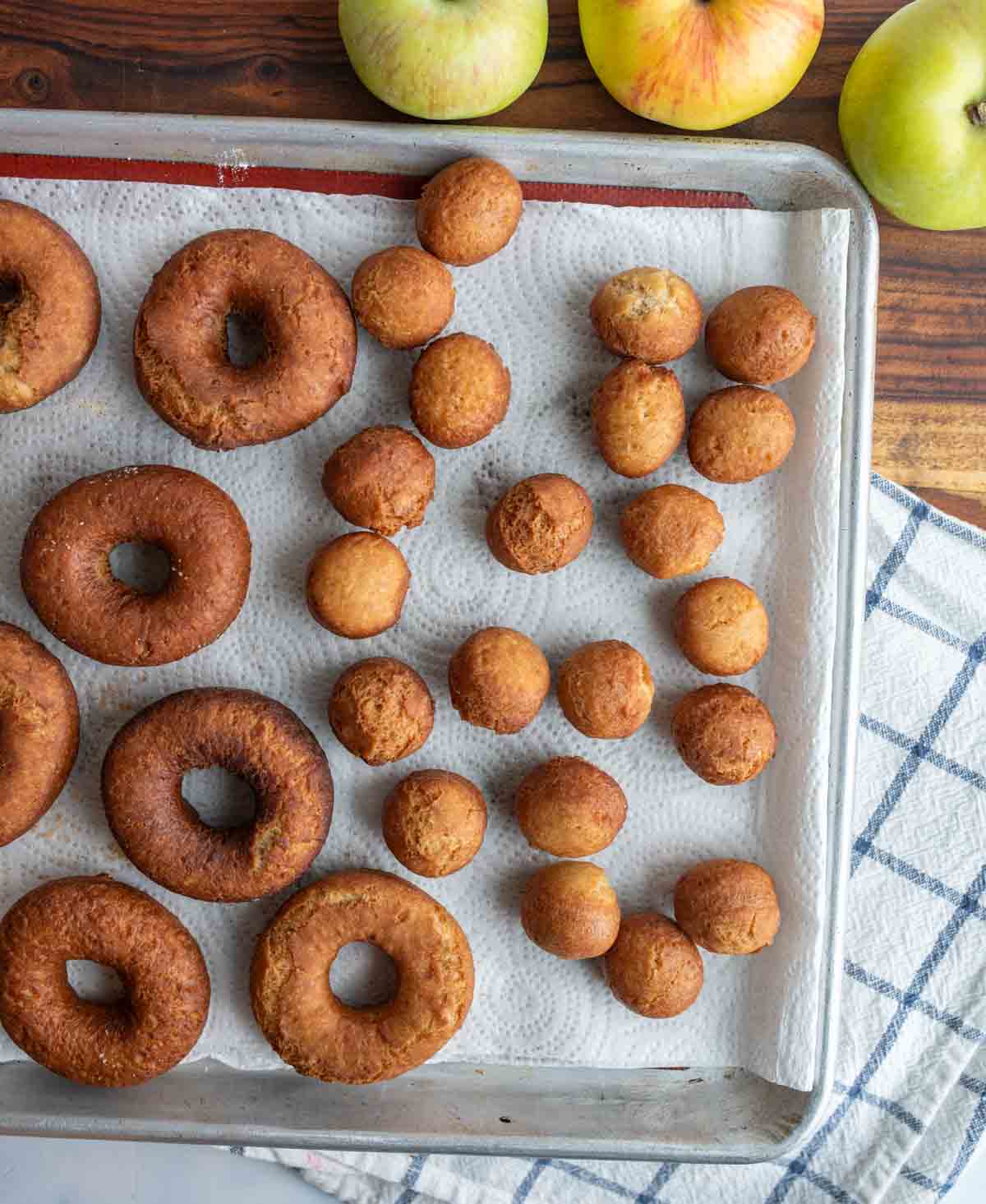 un-sugared apple cider donuts on a paper towel