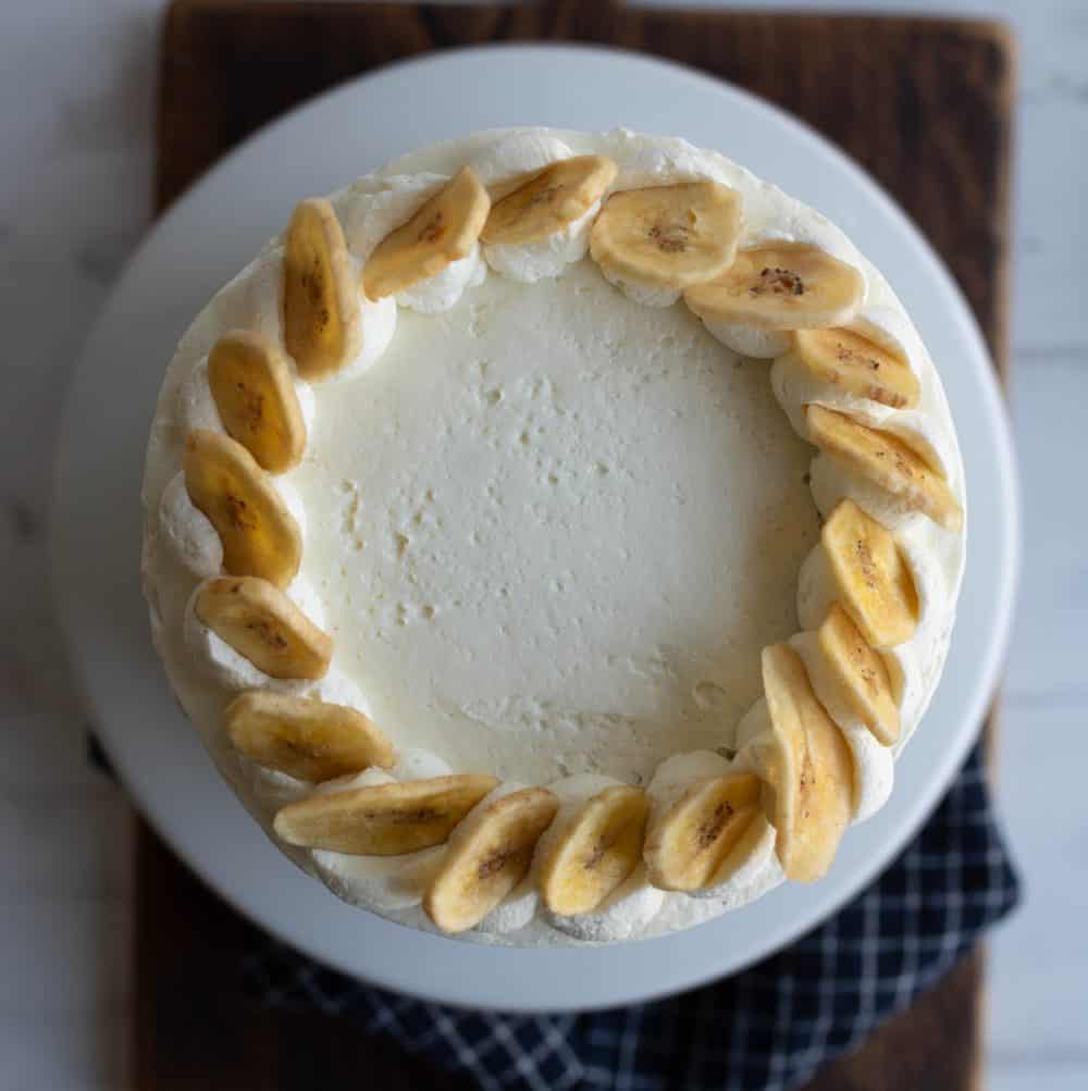 three layer banana cake with white frosting top view