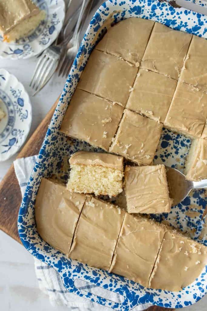 baking dish with squares of caramel cake cut out