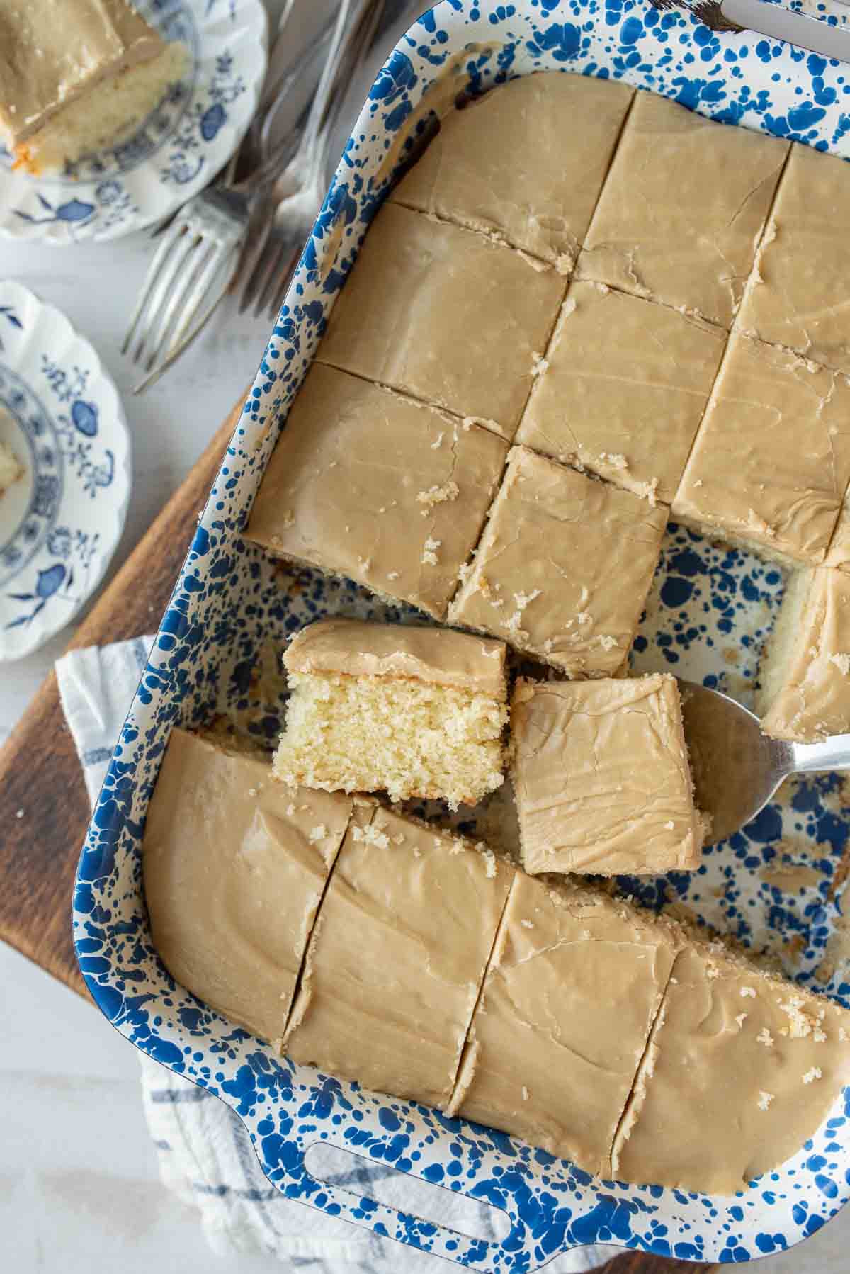 baking dish with squares of caramel cake cut out