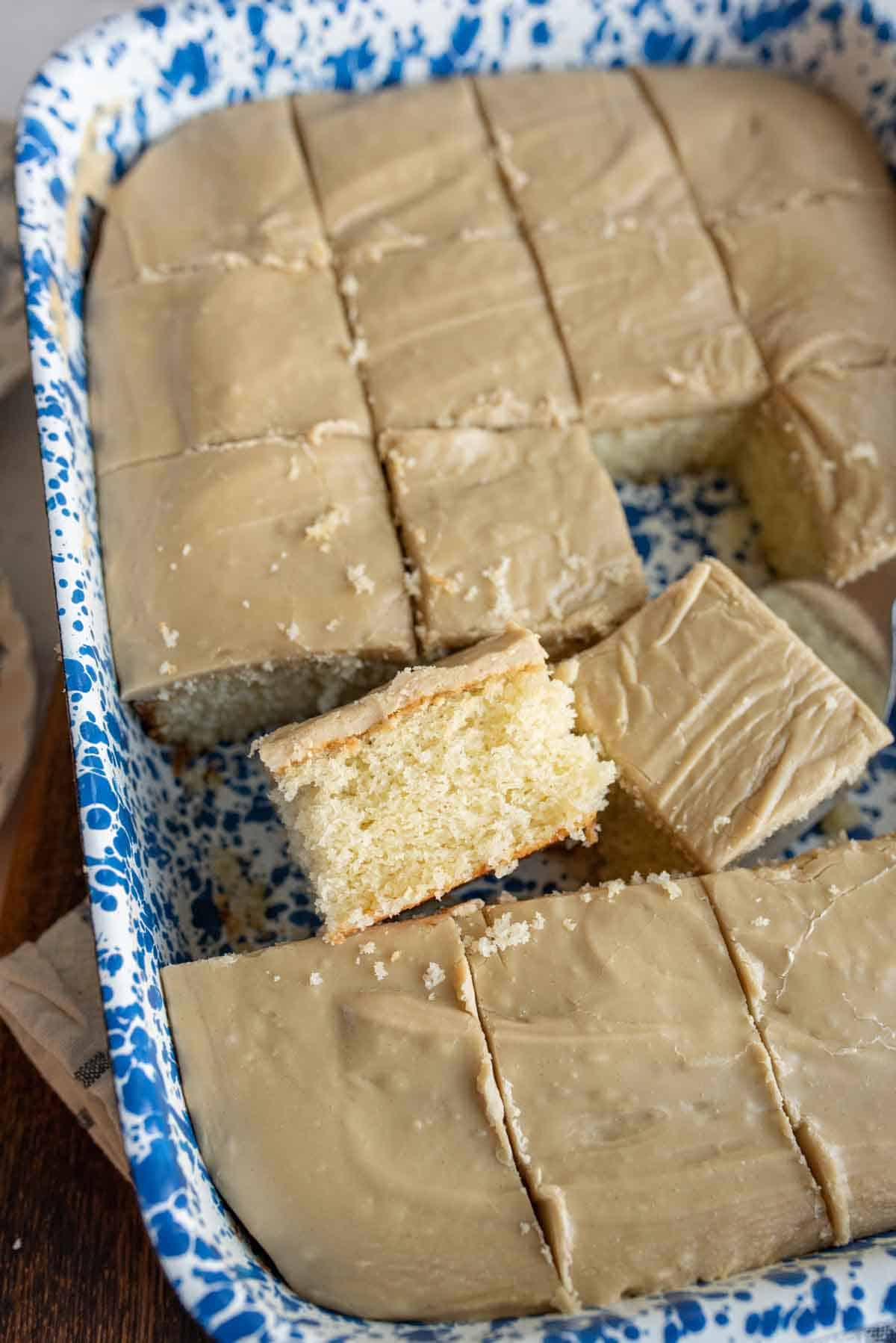 baking dish with squares of caramel cake cut out