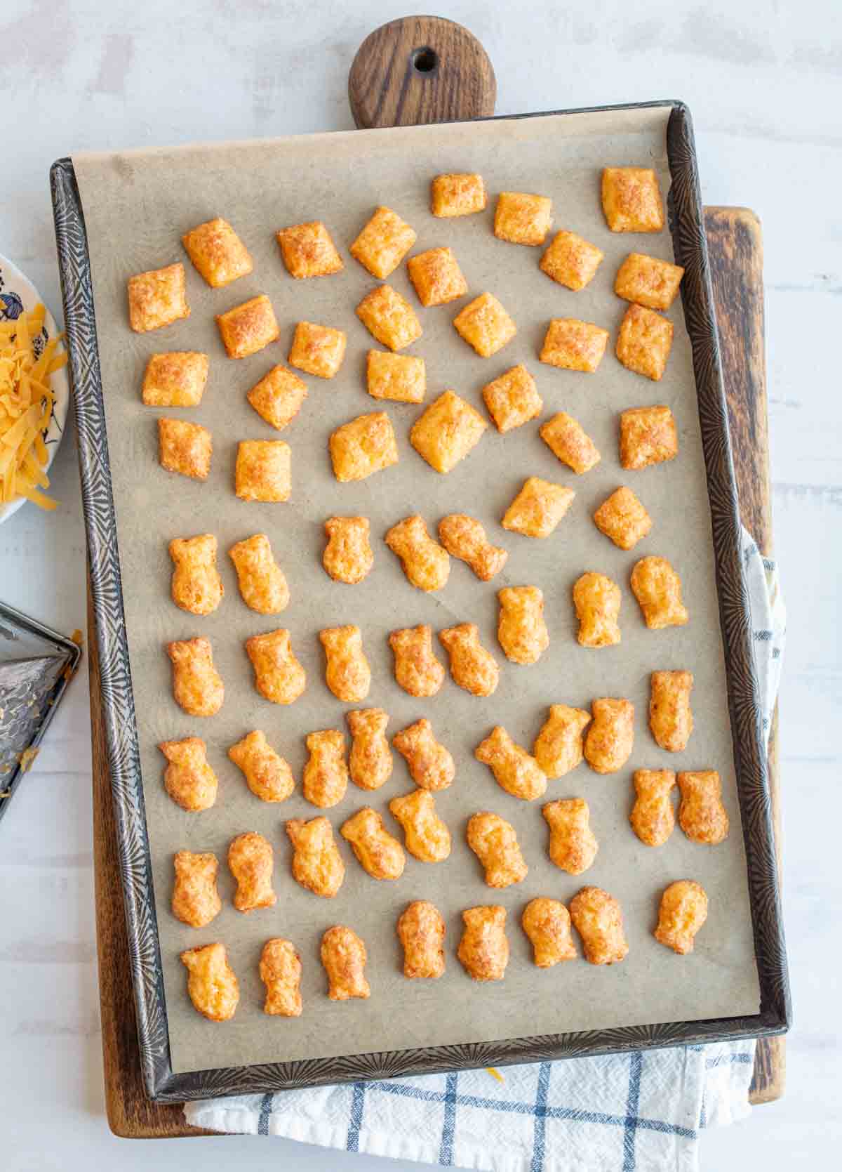 baked cheese crackers in a fish shape on a baking sheet