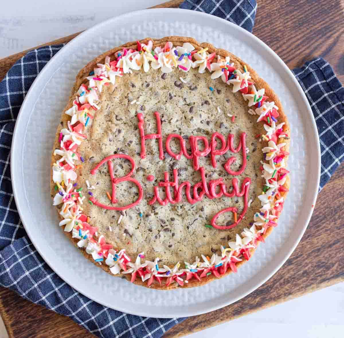 whole large round chocolate chip cookie cake with birthday decorations