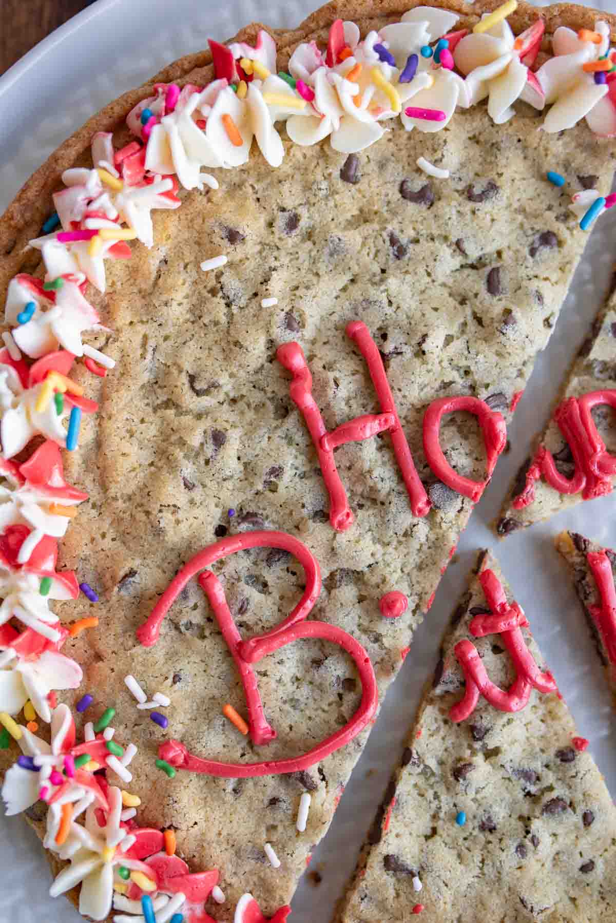 large round chocolate chip cookie cake with birthday decorations