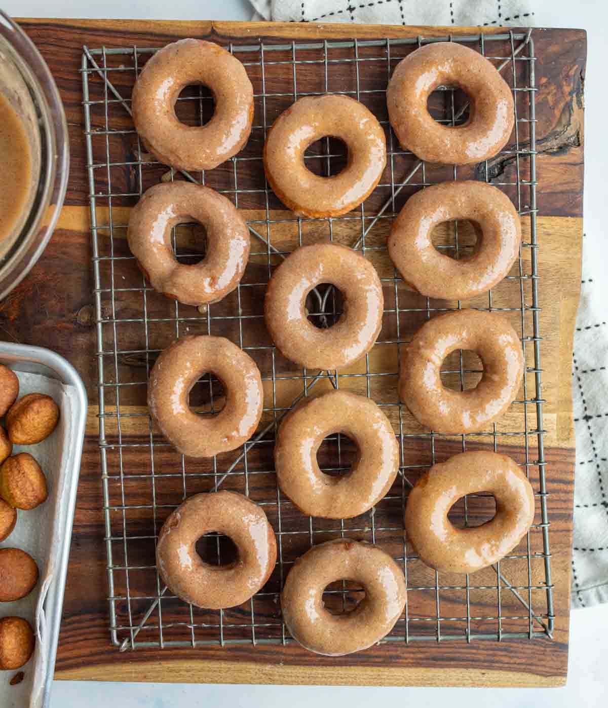 top view pumpkin donuts and holes glazed and on a cooling rack