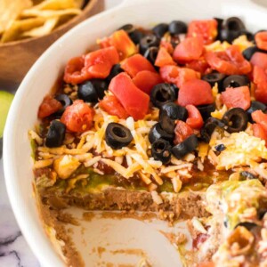 close up of a white baking casserole dish with 7 layer dip