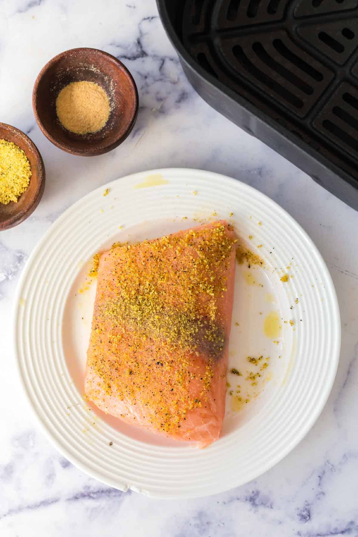 Seasonings on a filet of salmon.