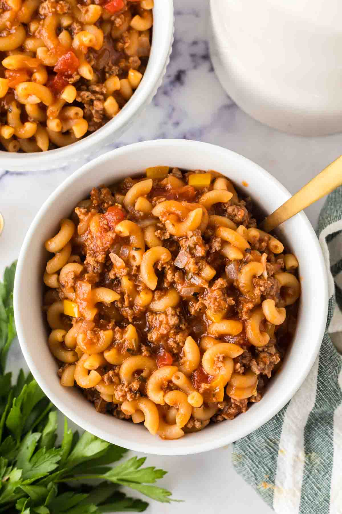 American chop suey served in a white bowl.