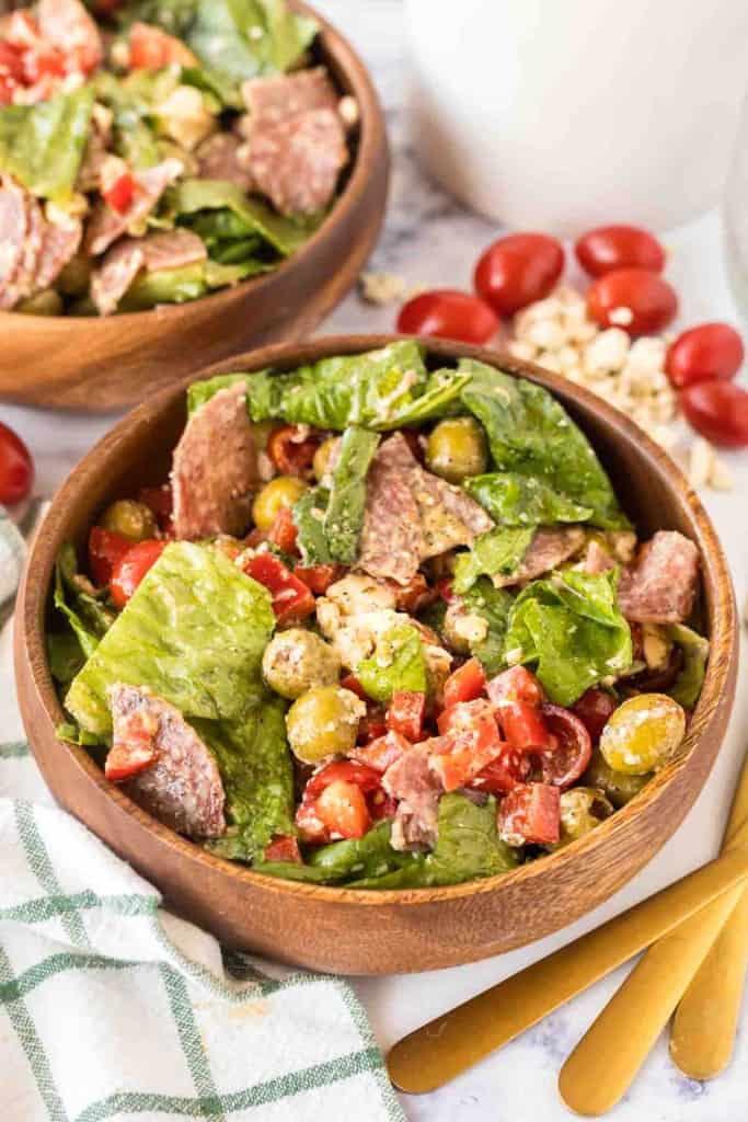 two wooden bowls with antipasto salad