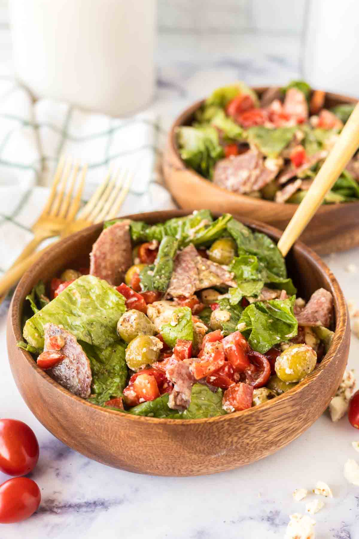 Antipasto salad served in a wooden bowl.