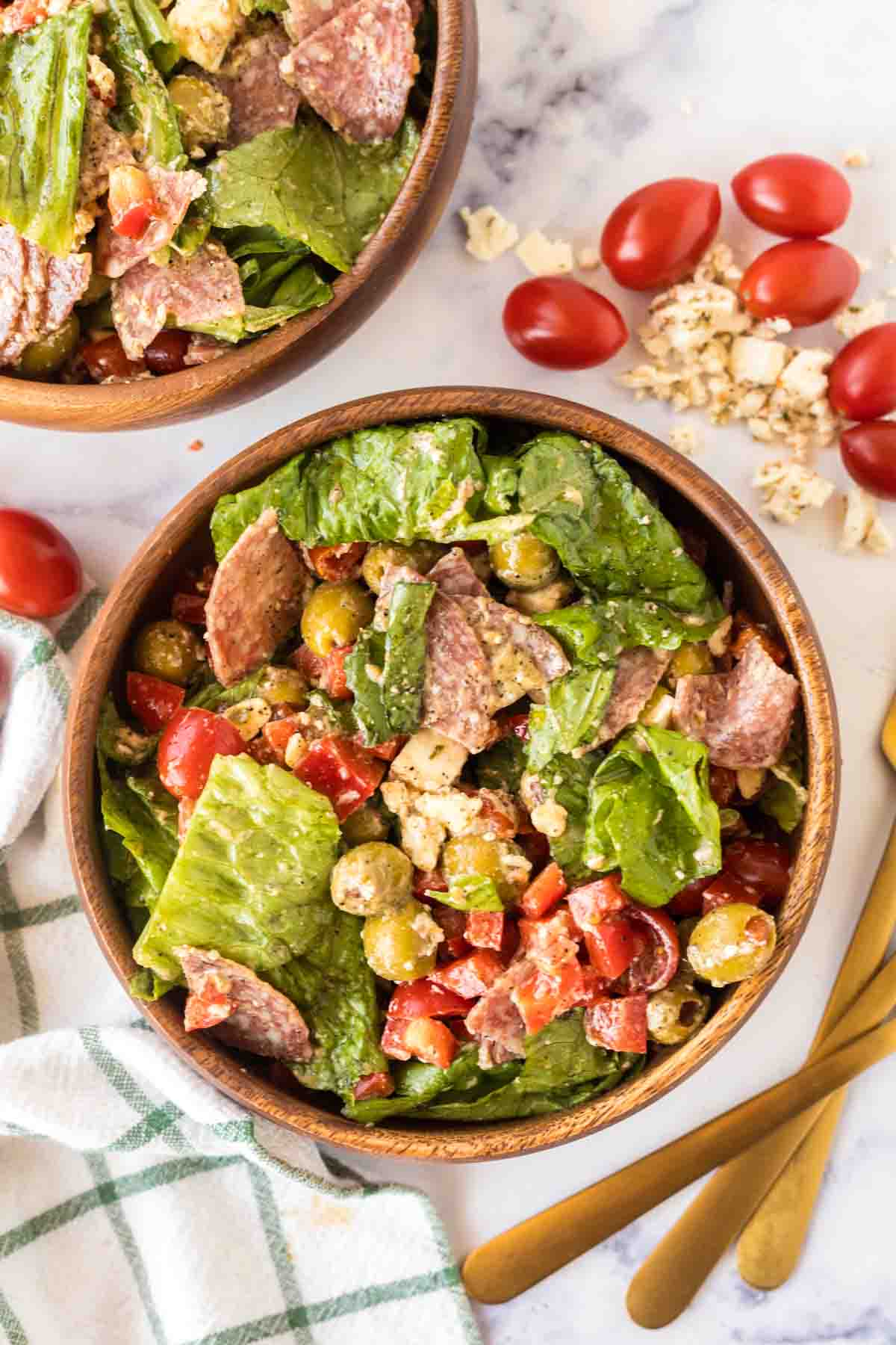 Fresh, green antipasto salad served in a wooden bowl.