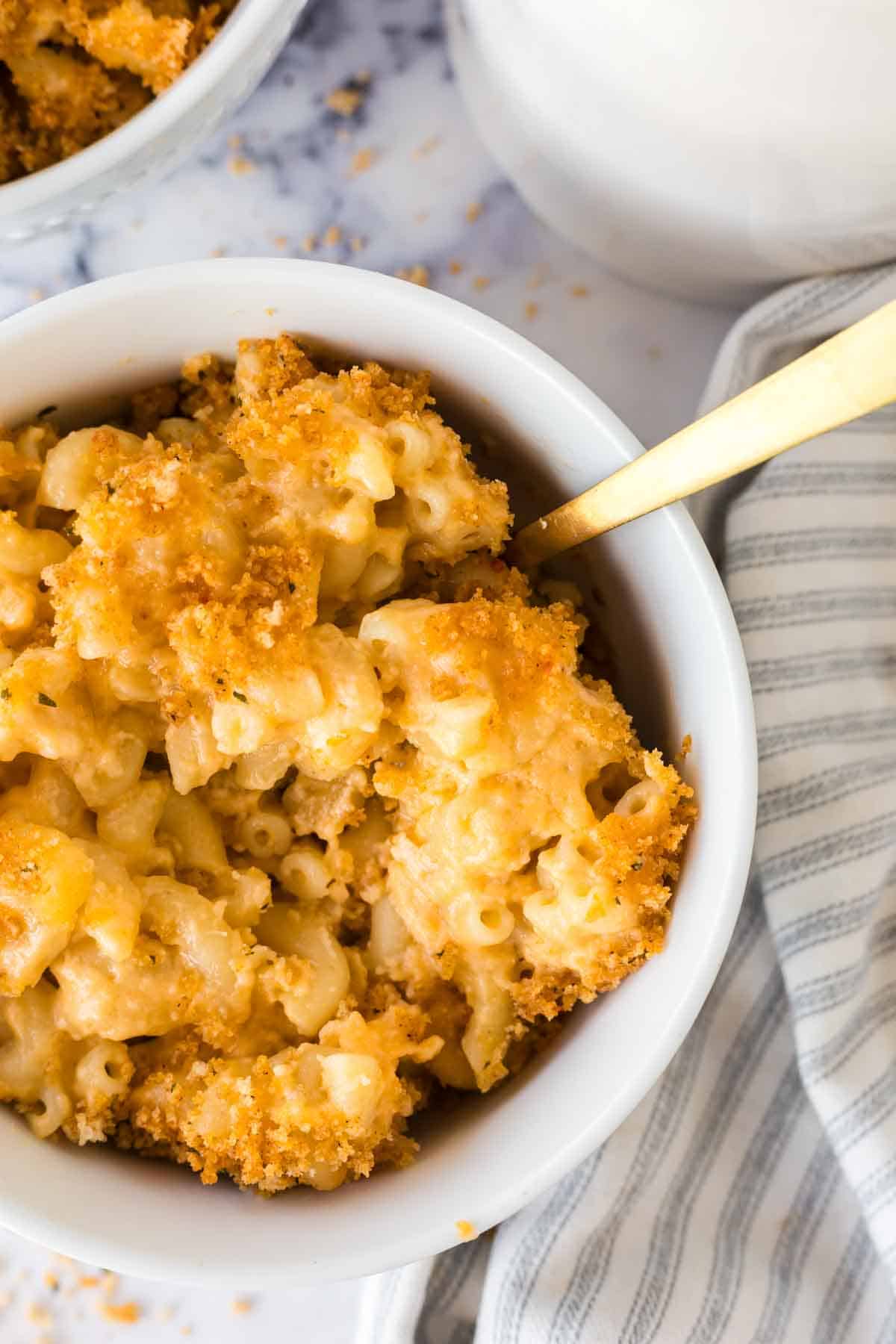 Close up view of finished baked mac n cheese served in a white bowl.