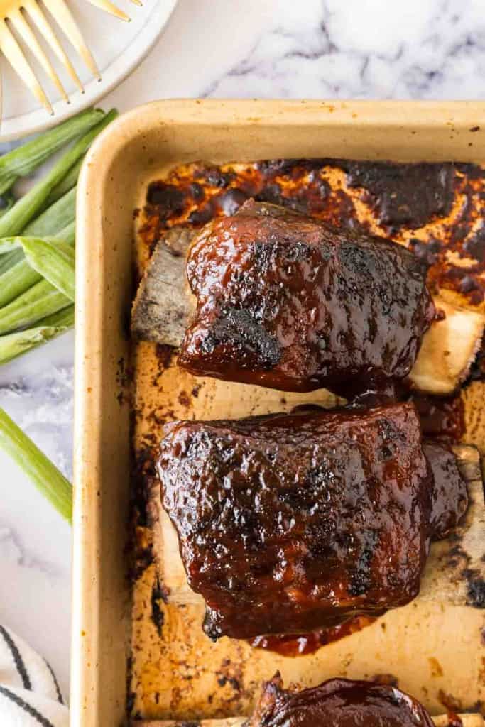 top view of beef ribs glazed on a baking sheet