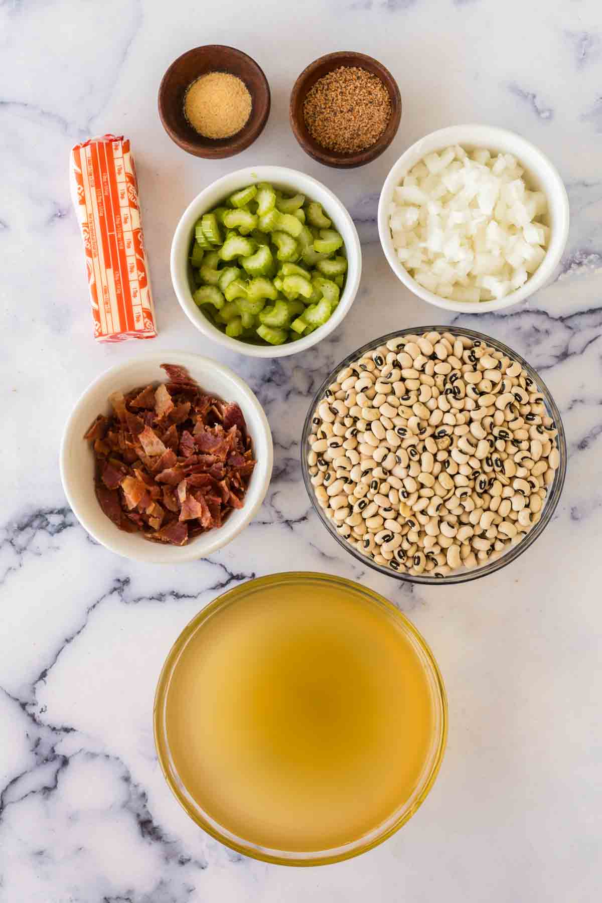 top view of portioned dishes with raw ingredients of black eyed peas